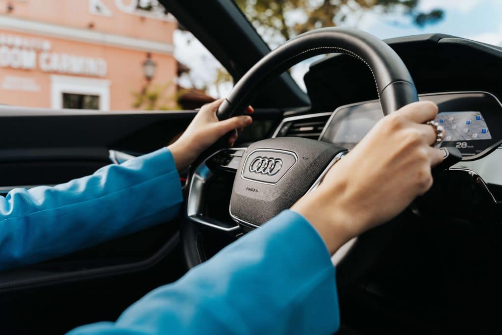 person holding steering wheel displaying good driving habits